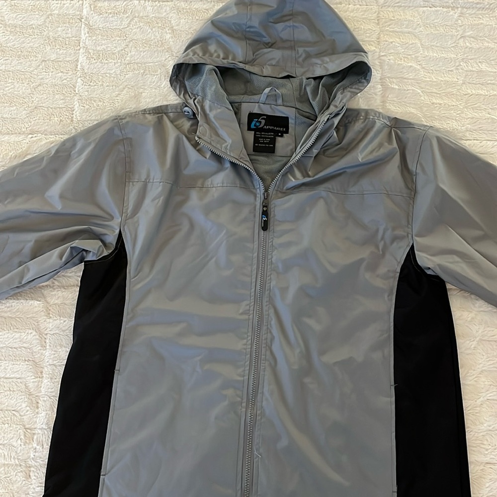 Gray and black hooded wind breaker with toggle pulls for hood